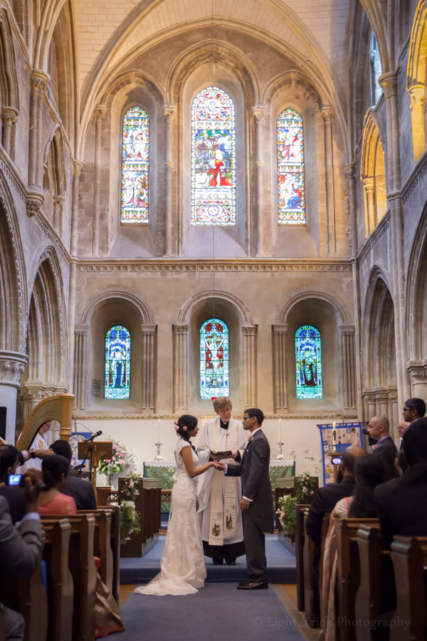 bride and groom holding hands at the front of the church